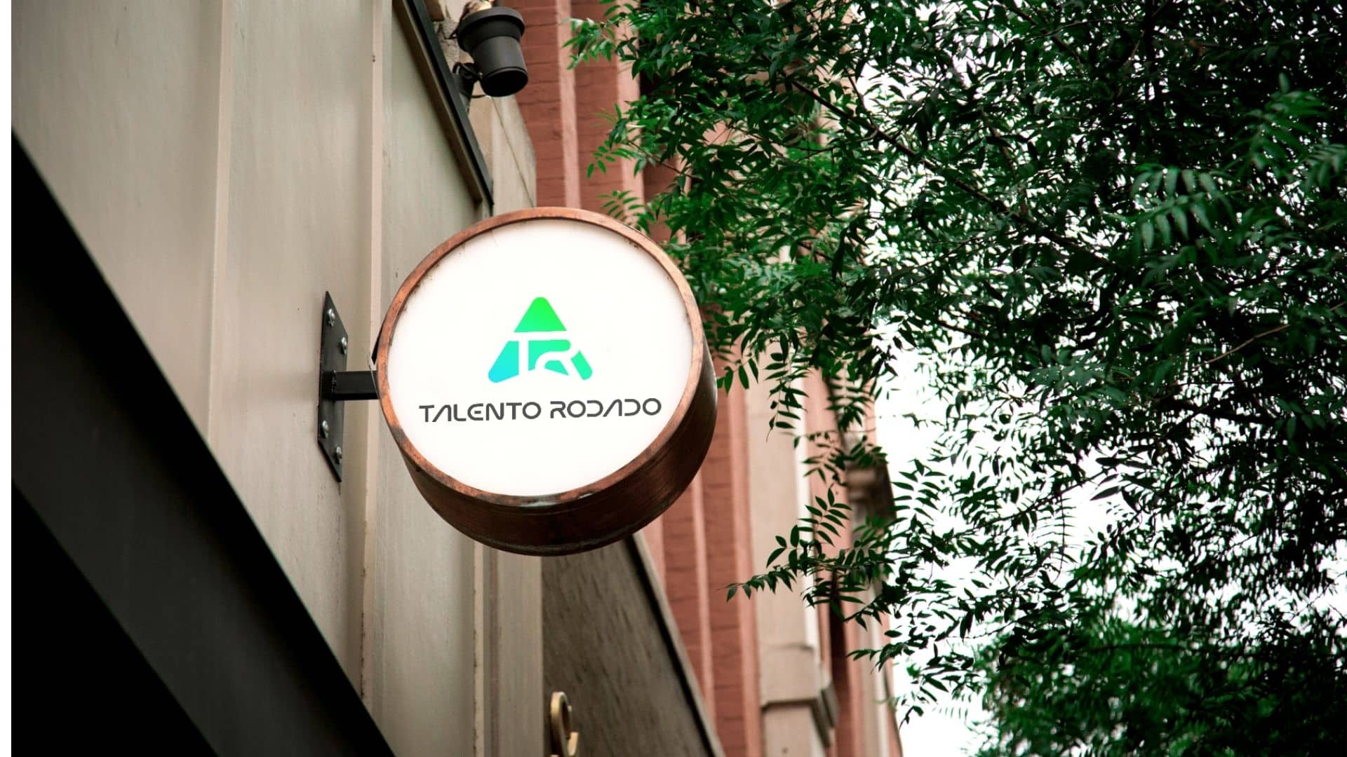 Round storefront sign showing a freshly designed brand logo