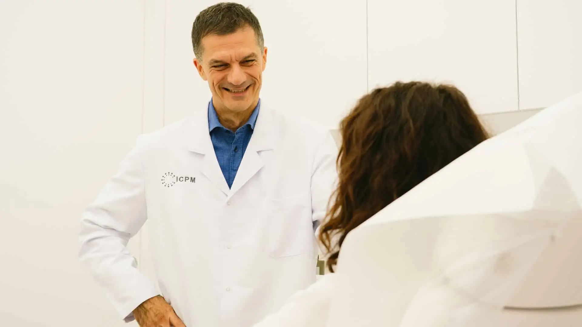 Dr. Alessandro Thione smiling with a patient in his clinic
