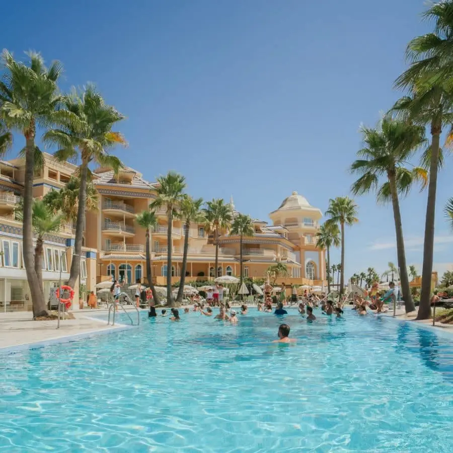 Pool and façade of Meliá Isla Canela on a sunny day